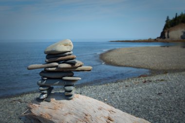 Inukshuk on a rock clipart