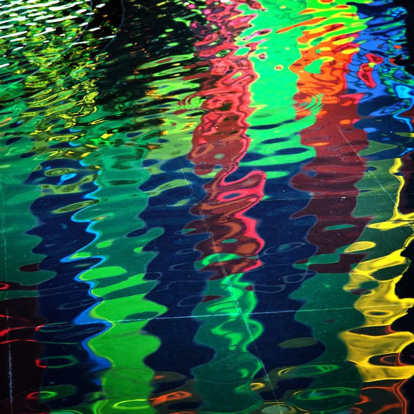 Colored lights reflexion in water — Stock Photo, Image