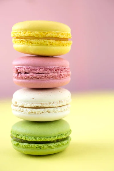 Macaron colorati su sfondo rosa e giallo — Foto Stock