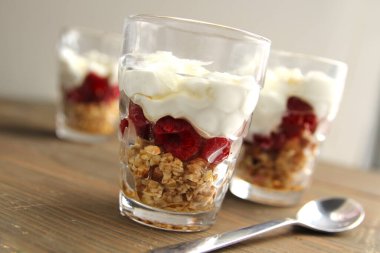 Fındıklı sade yoğurt ve ahşap arka planda bir kavanozda böğürtlen püresi