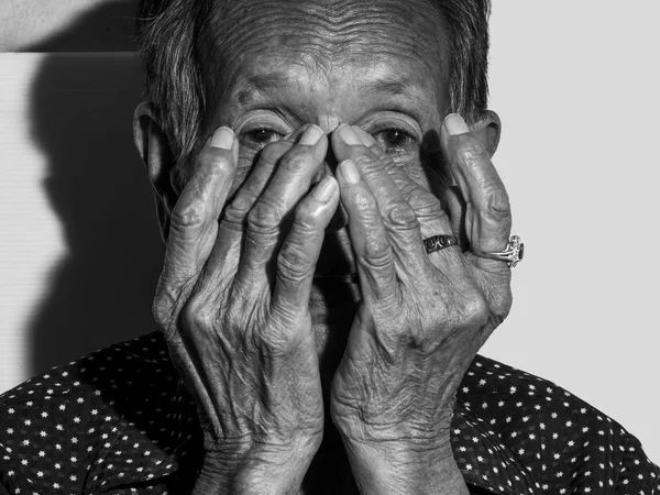 Ritratto donna anziana solitaria triste depresso, emozione, sentimenti, premuroso, anziano, donna anziana, attendere, cupo, preoccupato, coprendo il viso, espressioni volto umano, isolato sfondo nero — Foto Stock