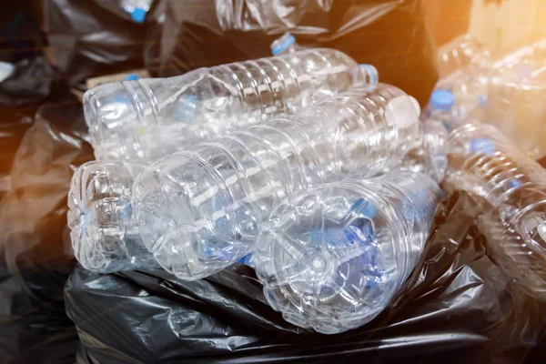 Plastic bottles in black garbage bags waiting to be taken to recycle. — Stock Photo, Image