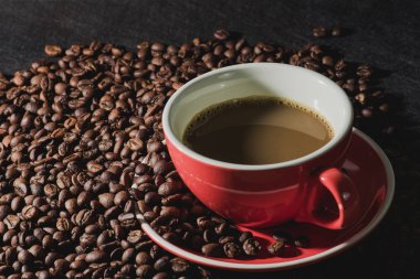 kahve kırmızı Kupası ve kahve çekirdekleri arka plan vardır.