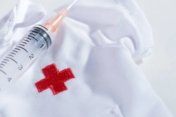 Red Cross hypodermic needle(injection needle) on white background.