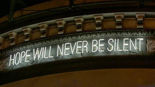 Neon sign on a building in Castro saying Hope will never be silent — стокове фото