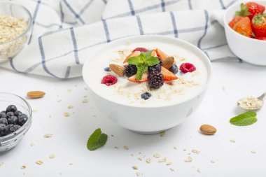 Tahıllı yoğurt, taze çilek, ahududu, yabanmersini, böğürtlen, badem ve nane. Sağlıklı atıştırmalıklar. Kahvaltı hazır.. 