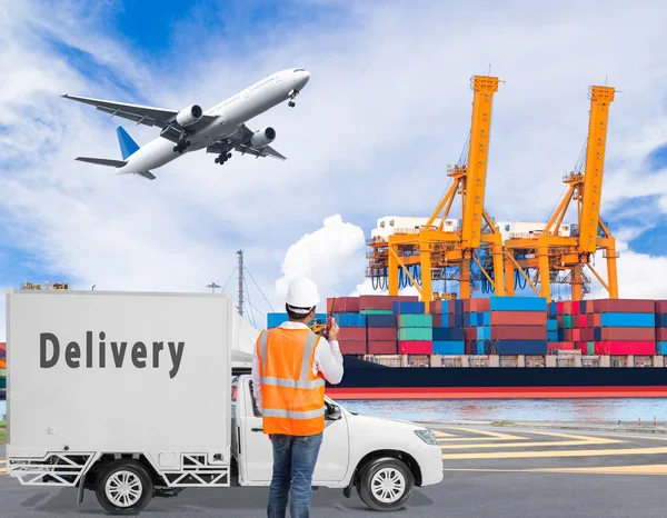 Poort ingenieur praten op de walkie-talkie voor controlerende laden container met levering vrachtwagens en lading vrachtvliegtuig vliegen boven de haven voor logistieke concept — Stockfoto