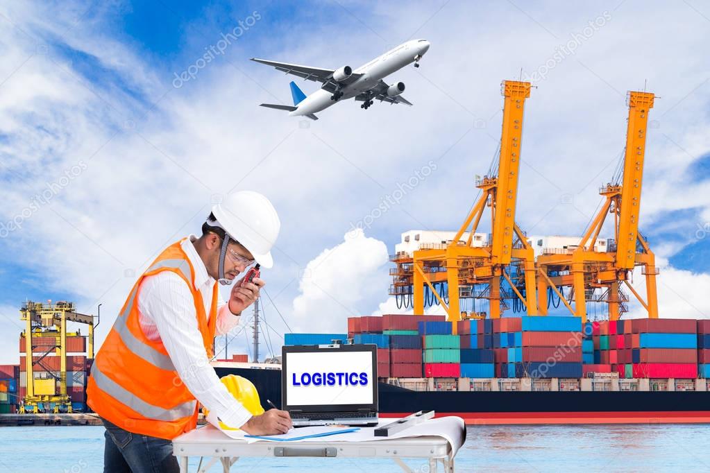 Engineer dockers talking on the walkie-talkie for controlling loading container and recording data in an industrial harbor for logistic Import export background