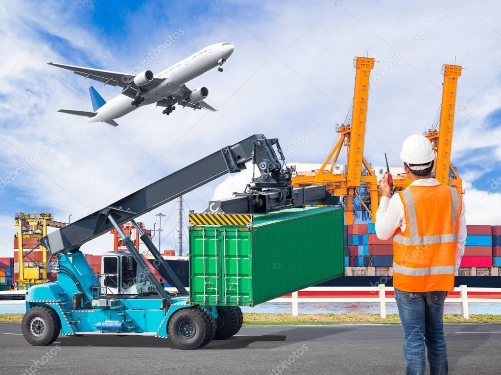 Dock worker talking with radio for controlling loading container in an industrial harbor with loading crane lifts container and cargo plane flying above ship port for logistic import export concept