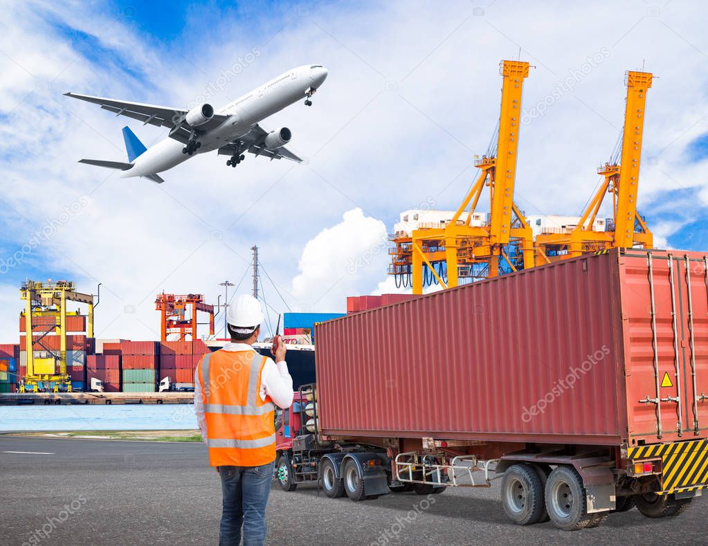 Dock worker talking on the walkie-talkie for controlling loading