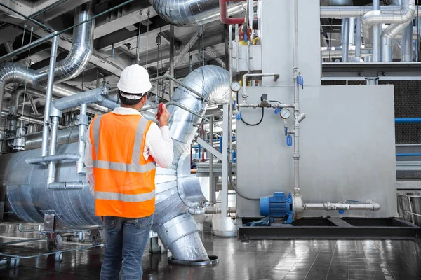 Engineer working in a thermal power plant with talking on the wa