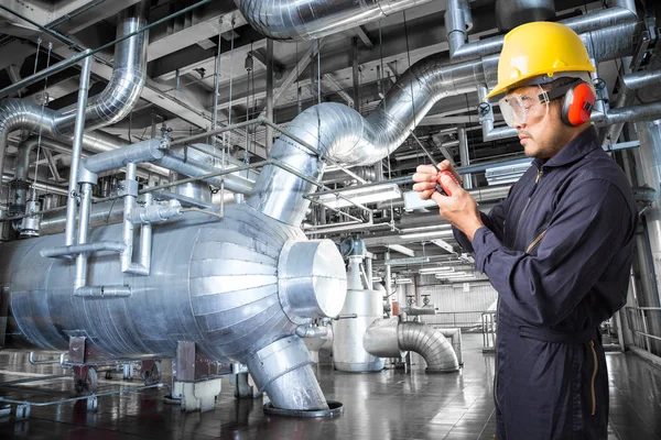 Engineer working in a thermal power plant with talking on the wa