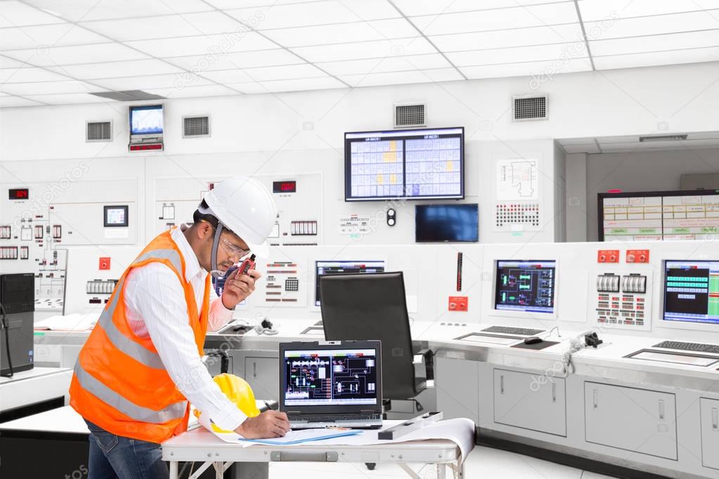 Engineer working at control room of thermal power plant 