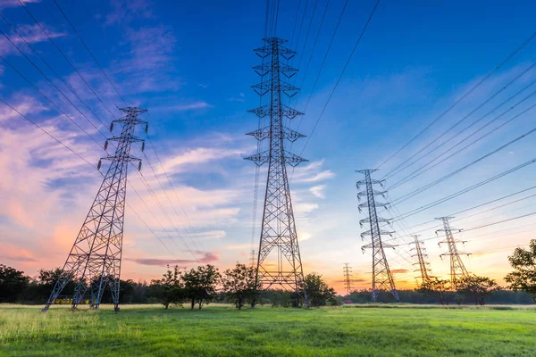 High voltage electricity pylon on sunrise background