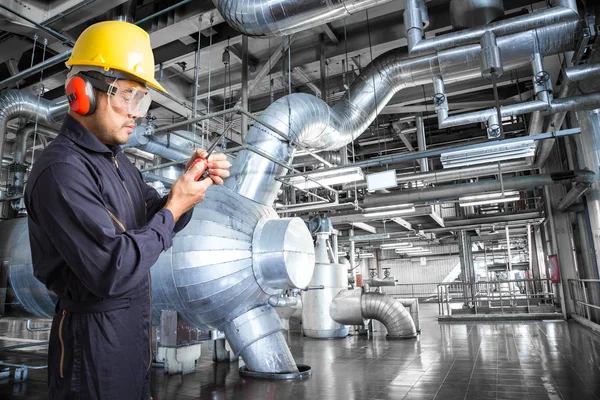 Engineer working in a thermal power plant with talking on the wa
