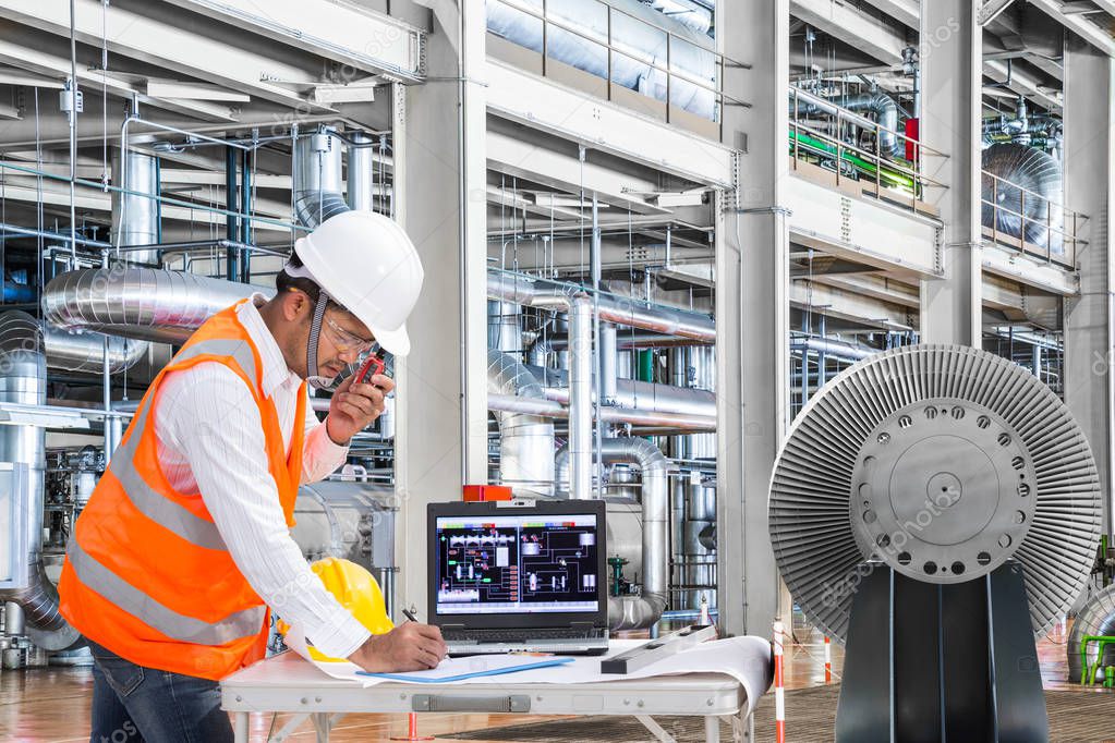 Engineer using laptop computer in thermal power plant factory