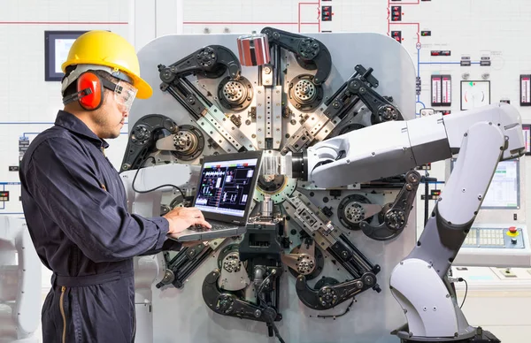 Engenheiro usando computador portátil para manutenção automática robótica máquina-ferramenta manual na fábrica, Indústria 4.0 conceito — Fotografia de Stock