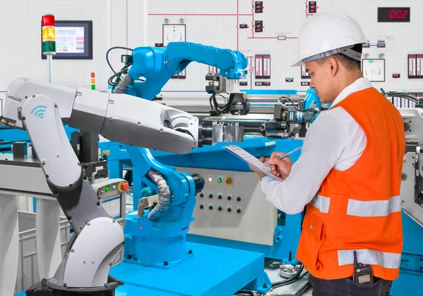 Ingeniero verificando mantenimiento diario de robótica automatizada en línea de producción, concepto Industria 4.0 —  Fotos de Stock