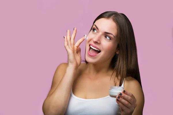 Woman with a skin care product — Stock Photo, Image