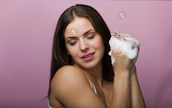 Beautiful young woman washing up her face
