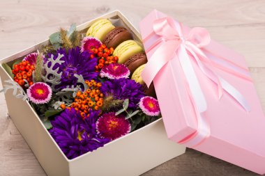 Box with flowers and macaroon cookies clipart