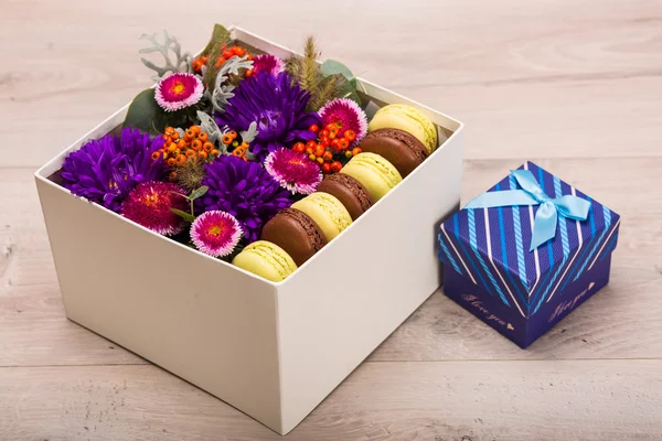 Caixa com flores e biscoitos macaroon — Fotografia de Stock