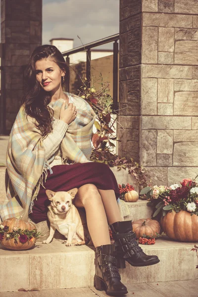 Pretty woman sitting on a decorated porch — Stock Photo, Image