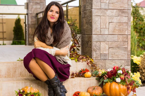 Mujer bonita sentada en un porche decorado — Foto de Stock