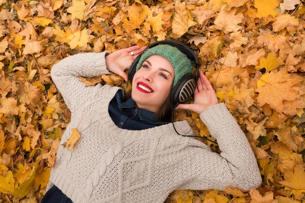 Woman in the autumn leaves Royalty Free Stock Images