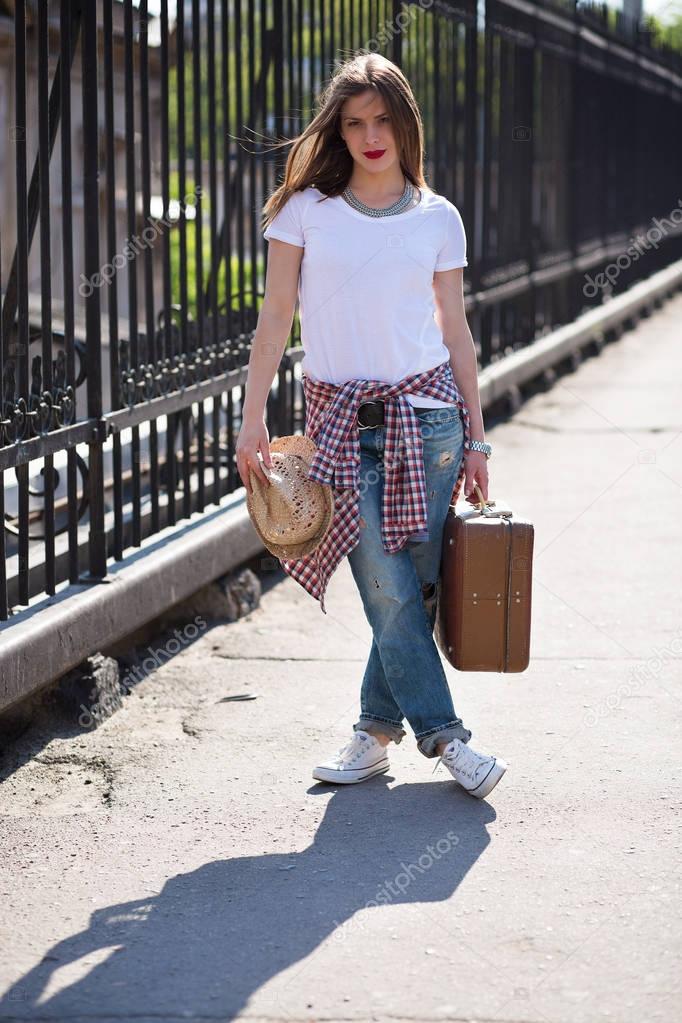 Woman with a suitcase in the city