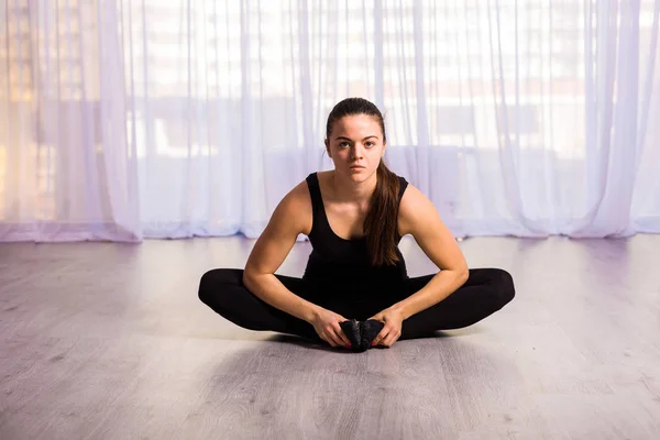 Mujer estirándose en el estudio — Foto de Stock