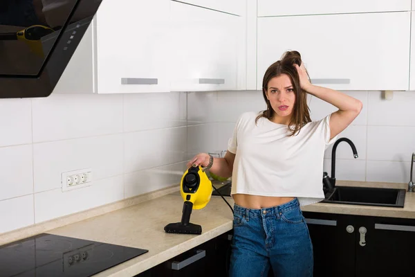Woman cleaning kitchen with steam cleaner — Stock Photo, Image