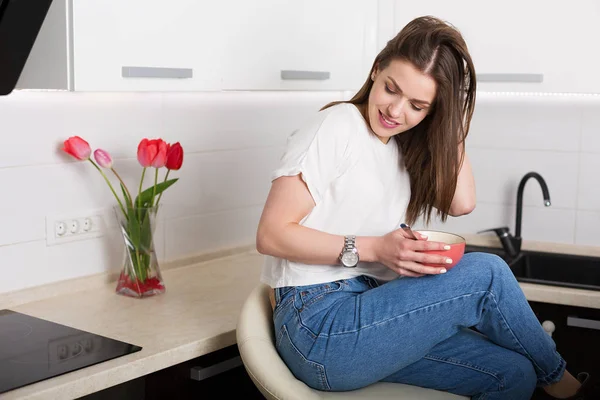 stock image Woman eating breakfast at her kitchen