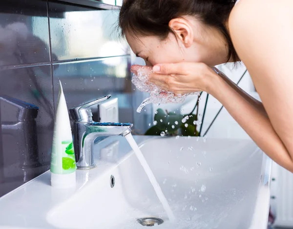 Woman washing up in the morning