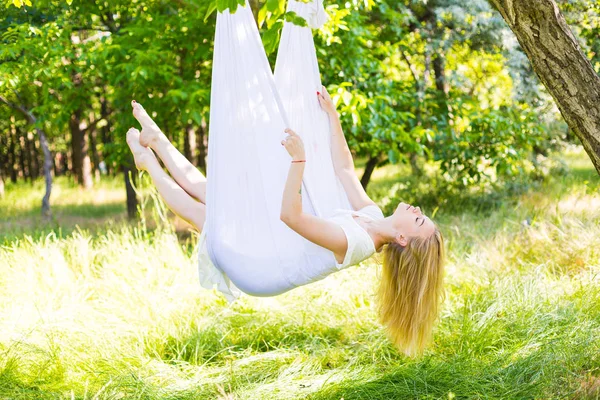 Beautiful woman swinging in white hammock — Stock Photo, Image