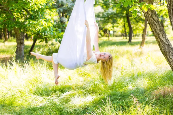 Beautiful woman swinging in white hammock — Stock Photo, Image