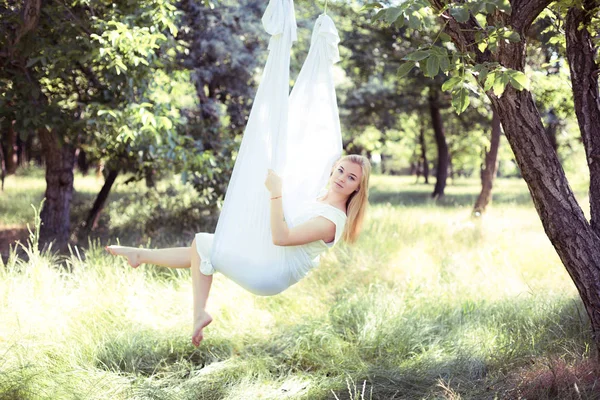 Beautiful woman swinging in white hammock — Stock Photo, Image