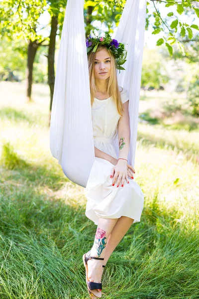 Beautiful woman swinging in white hammock — Stock Photo, Image