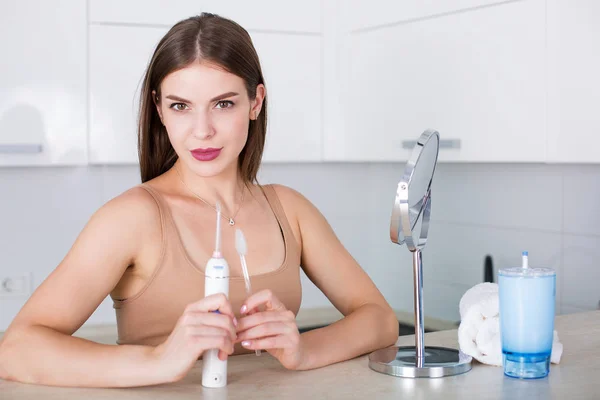 Woman with toothbrush and oral irrigator — Stock Photo, Image