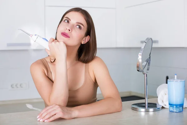 Woman with toothbrush and oral irrigator — Stock Photo, Image