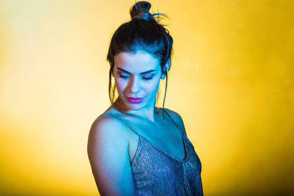 Beautiful woman posing in disco lights