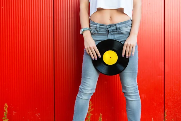 Mujer sosteniendo un disco de vinilo — Foto de Stock