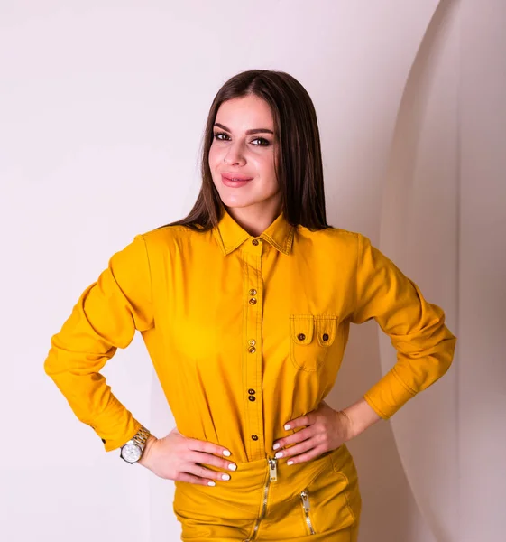 Beautiful woman in yellow shirt and skirt