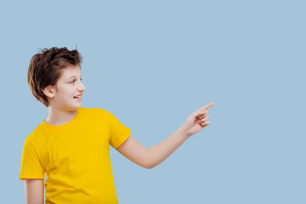 Jong jongen wijzend zijn vinger naar de linkerkant, — Stockfoto