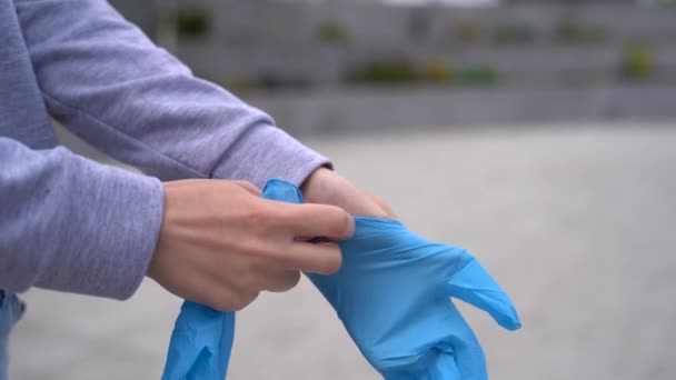 Woman Puts on Protective Gloves to Prevent Transmission of Pathogens Protecting — Stock Video