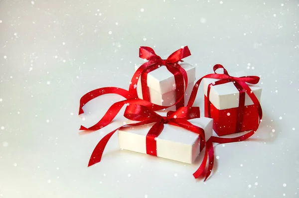 Christmas Gift's in White Box with Red Ribbon on Light Background. New Year Holiday Composition — Stock Photo, Image