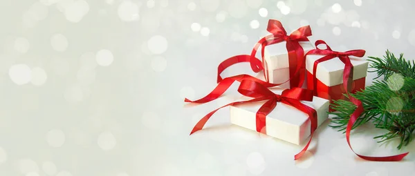 Christmas Gift's in White Box with Red Ribbon on Light Background. New Year Holiday Composition Banner. Copy Space — Stock Photo, Image