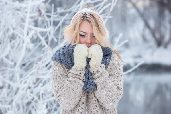 Beautiful girl in pink headphones on the scarf with snow — Stock Photo, Image