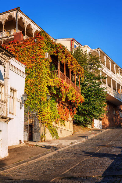 Exterior of an old house with wood balcony in the old town of Tbilisi, Georgia.