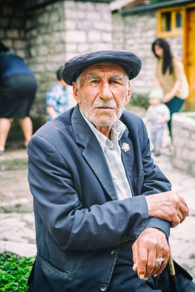 Portrait of Blind tanner in Lahic, making belts for the saddle